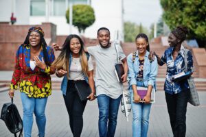 Group of five african college students spending time together on